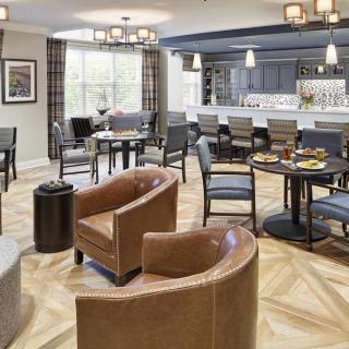 A modern restaurant interior with comfortable seating and a stylish bar area.