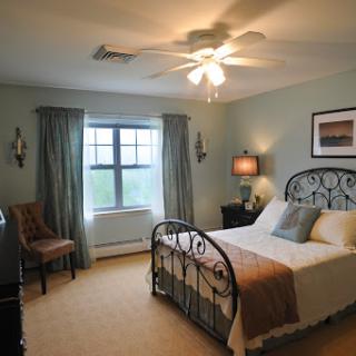 A cozy bedroom featuring a metal bed frame, soft lighting, and a calming color palette.