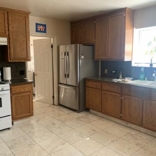 A spacious kitchen with wooden cabinets and modern appliances.
