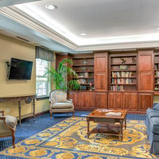 A cozy living room with built-in bookshelves and comfortable seating.