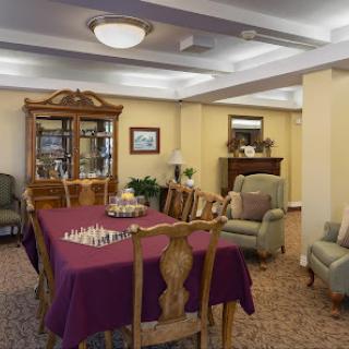 A cozy indoor dining area featuring a chess table and comfortable seating.