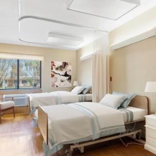 A clean and modern hospital room with two beds.