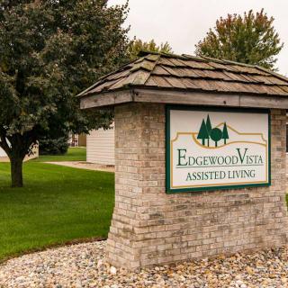 Entrance sign to the Englewood West subdivision, set amidst a landscaped area with trees and grass.