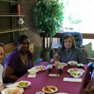 A group of people enjoying a meal together at a table indoors.