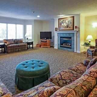 A cozy living room with a fireplace, television, and comfortable seating.