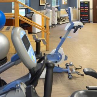 A well-equipped gym with stationary bikes and various workout machines.