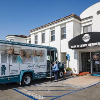 A food truck parked outside the Poke Organic Restaurant with a person standing nearby in a parking lot.