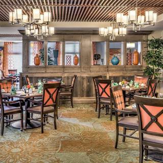 Elegant restaurant interior with beautifully arranged tables and chandeliers.