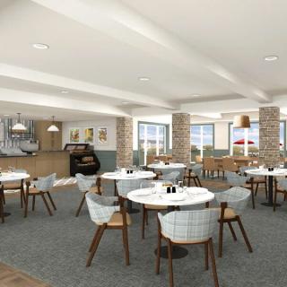 A modern restaurant interior with neatly arranged tables and chairs, featuring stylish decor.