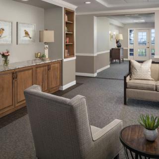 A cozy living room with comfortable seating, decorative artwork, and soft lighting.