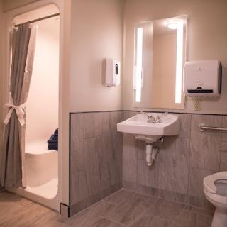 A modern and clean bathroom equipped with a sink, toilet, and shower.
