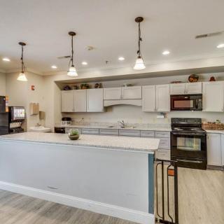 A modern kitchen with an island and pendant lighting.