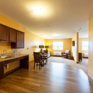 A spacious and well-lit apartment featuring a kitchen and dining area.