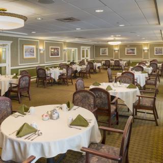 An elegant dining room with neatly arranged tables and chairs, ready for guests.
