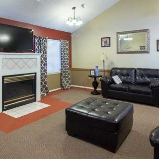 Cozy living room with a fireplace, television, and comfortable seating.