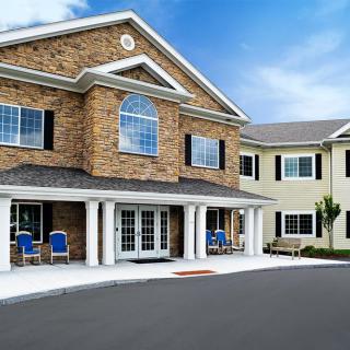A modern residential building with brick facade and columns.
