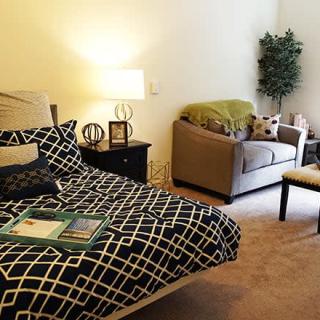 Cozy bedroom with modern decor and comfortable seating.