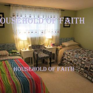 A cozy bedroom with two twin beds, colorful bedding, and decorative lamps on nightstands.