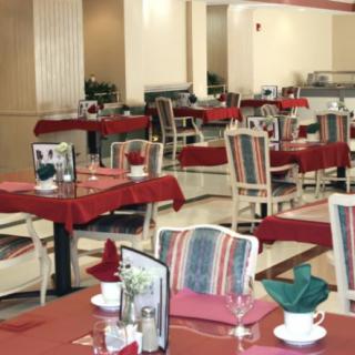 An indoor restaurant dining area with tables and chairs neatly arranged.