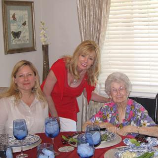 Three women enjoying a meal together at a dining table.