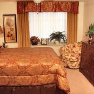 A cozy bedroom with warm-colored decor and furniture.