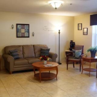 A cozy living room with a sofa, coffee table, and artwork on the walls.
