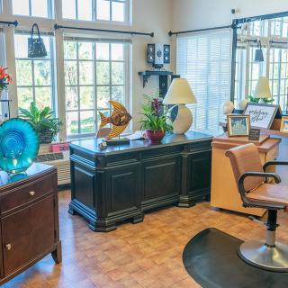 A cozy hair salon interior with stylish furniture and ample natural lighting.