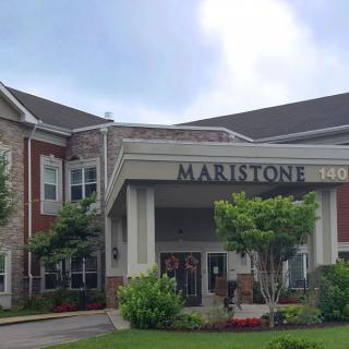 Front entrance of a residential building with well-maintained landscaping.