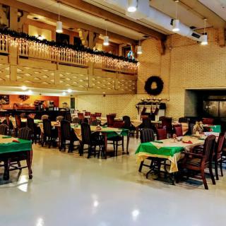 An elegant restaurant interior with neatly arranged tables and chairs, ready for guests.