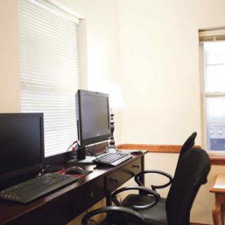 A tidy home office with a dual monitor computer setup.