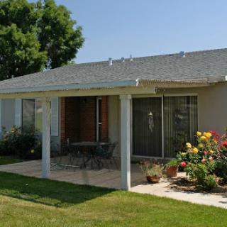 A charming home with a welcoming front porch and vibrant garden.