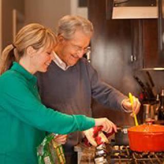 Two people cooking together in a kitchen.