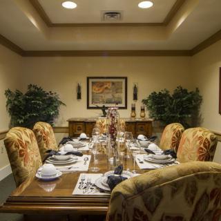A formally set dining room table with elegant chairs and decor.