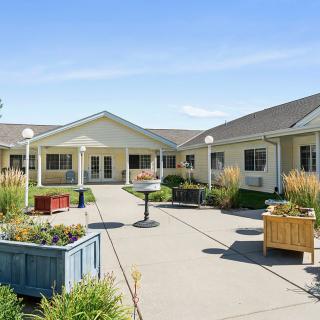 A sunny day in a well-maintained courtyard with landscaping and a pathway.