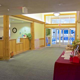 A spacious lobby with a reception desk and entrance doors.