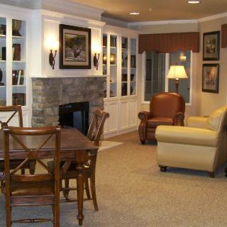 A cozy living room with a fireplace, dining area, and comfortable seating.