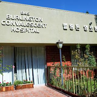 Exterior view of Burlington Convalescent Hospital, showcasing its signage and surrounding greenery.