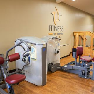 An interior view of a gym showcasing various fitness machines for strength training.