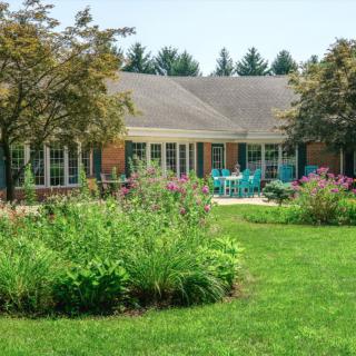 A cozy house with a well-maintained garden and patio area.