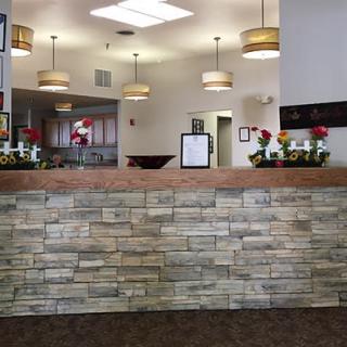 A welcoming reception area with decorative lighting and flowers on the counter.