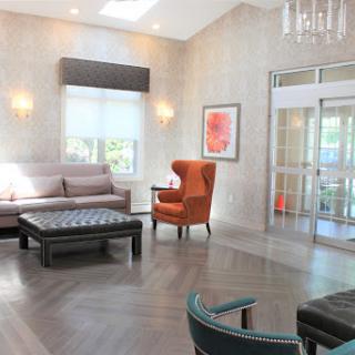 A modern and cozy lobby featuring stylish furniture and a bright atmosphere.