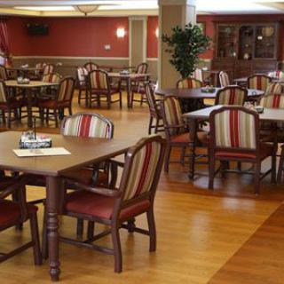 An empty dining room with neatly arranged tables and chairs.