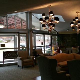 A cozy lobby interior with comfortable seating and elegant chandeliers.