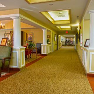 A well-lit interior hallway with seating areas and decorative elements.