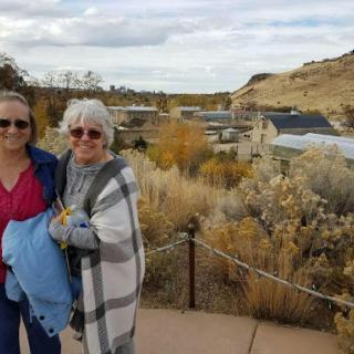 Two friends enjoying a scenic view during an autumn outing.