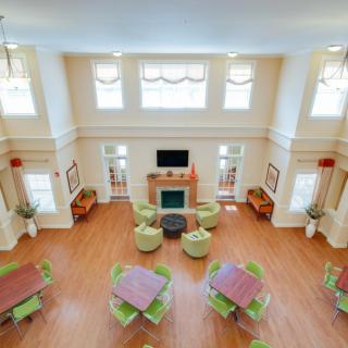 A spacious and elegant living room with seating arrangements and a fireplace.