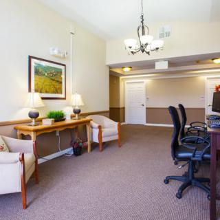 A spacious office interior with desks and computers arranged for work or meetings.