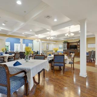 A spacious and well-lit dining area with elegant decor and neatly arranged tables.