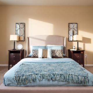 A well-decorated bedroom with modern furnishings and neutral tones.