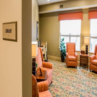 A cozy waiting room with patterned carpet and comfortable seating.